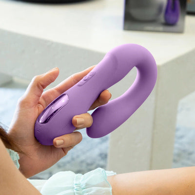 Young lady holding the Rabbit Reflexx Vibrator purple color