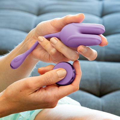 Model holding vibrating kegel Trainer and remote control power button